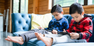 Two boys playing on iPads.