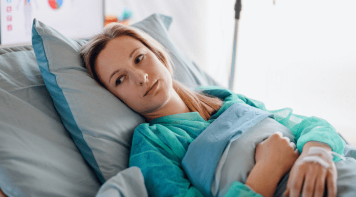 A woman in a hospital bed.