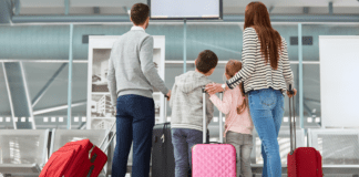 A family with their luggage at the airport.