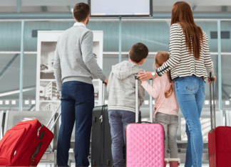 A family with their luggage at the airport.