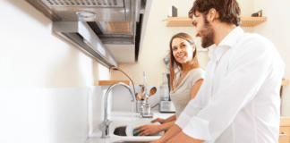 The Gift of Not Doing Everything Sharing the mental load with a husband and wife doing the dishes.