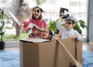 Interactive Play Ideas to Keep Your Kids Busy Over Winter Break Kids pretending a cardboard box is a pirate ship.