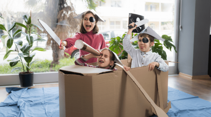 Interactive Play Ideas to Keep Your Kids Busy Over Winter Break Kids pretending a cardboard box is a pirate ship.