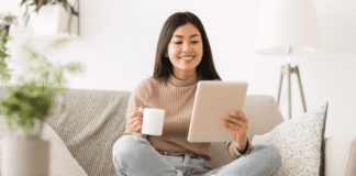 Westchester County Mom Top 10 Posts of 2024 A woman drinking coffee and reading on her tablet.