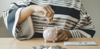 Putting money in a piggy bank.