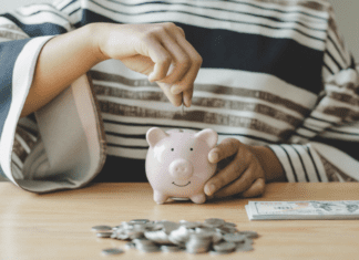 Putting money in a piggy bank.
