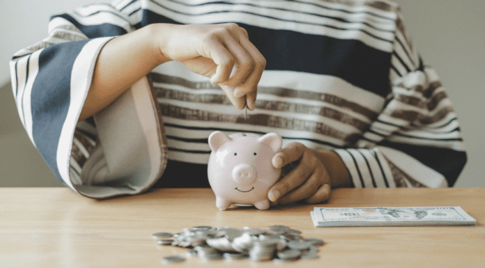 Girls Just Wanna Have Funds Putting money in a piggy bank.