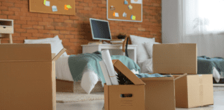 When I Sent My Eldest to College A college dorm room with boxes ready for someone to move in.