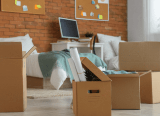 A college dorm room with boxes ready for someone to move in.
