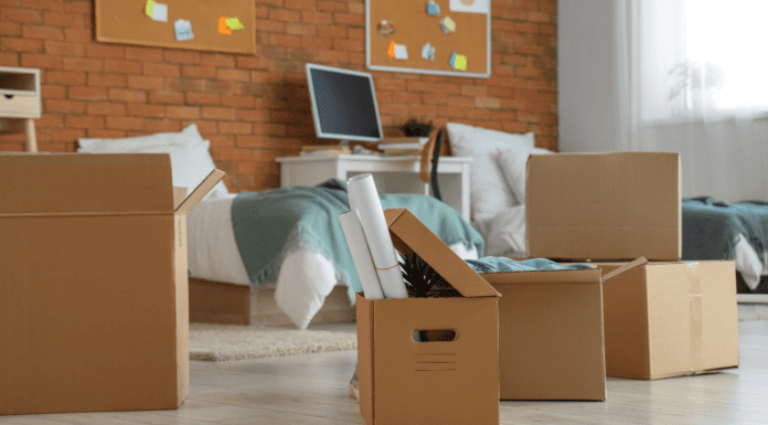 When I Sent My Eldest to College A college dorm room with boxes ready for someone to move in.