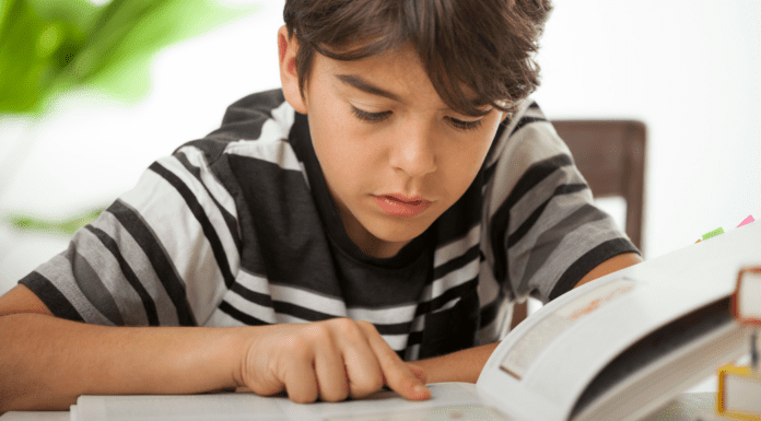 Our Journey with Dyslexia: Trusting My Instincts as a Mom A boy reading a book.