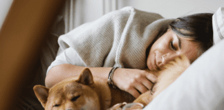 Mommy Comes First (For Once!) A woman laying down with her dog.