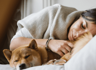 Mommy Comes First (For Once!) A woman laying down with her dog.