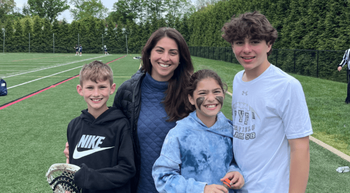 A Type A/B mom with her children on a lacrosse field.
