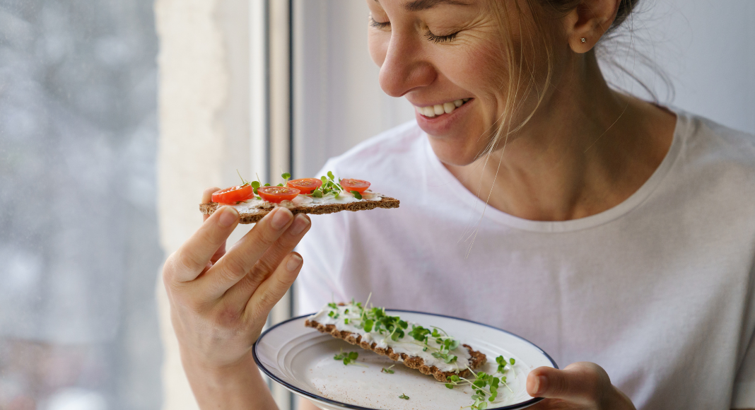 A woman eating a healthy snack.