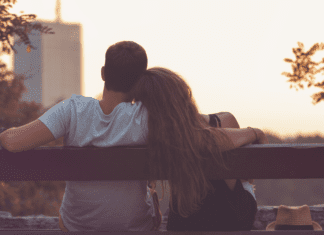 Learning To Love Again: Preparation & Mndset A couple cuddling together on a park bench.
