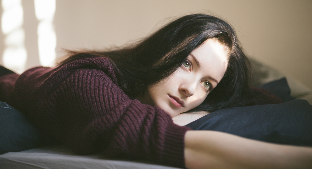 A woman who lost her spark laying on the couch.