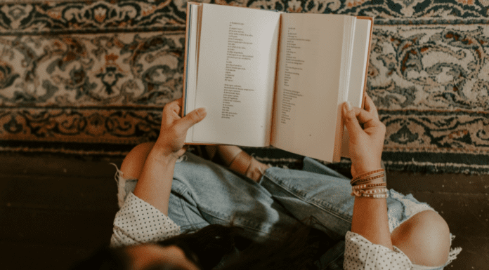 Someone holding a book of poetry.