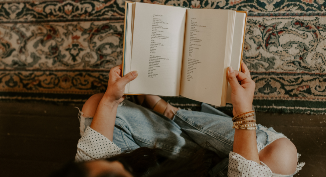 Someone holding a book of poetry.