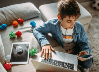 A boy on his computer and phone.