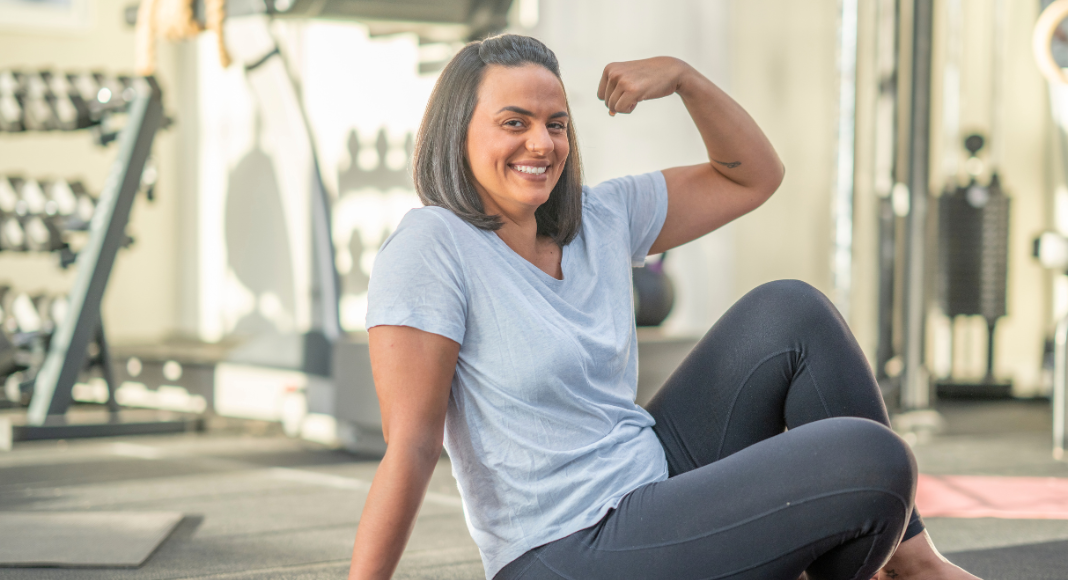 A strong woman making a muscle.