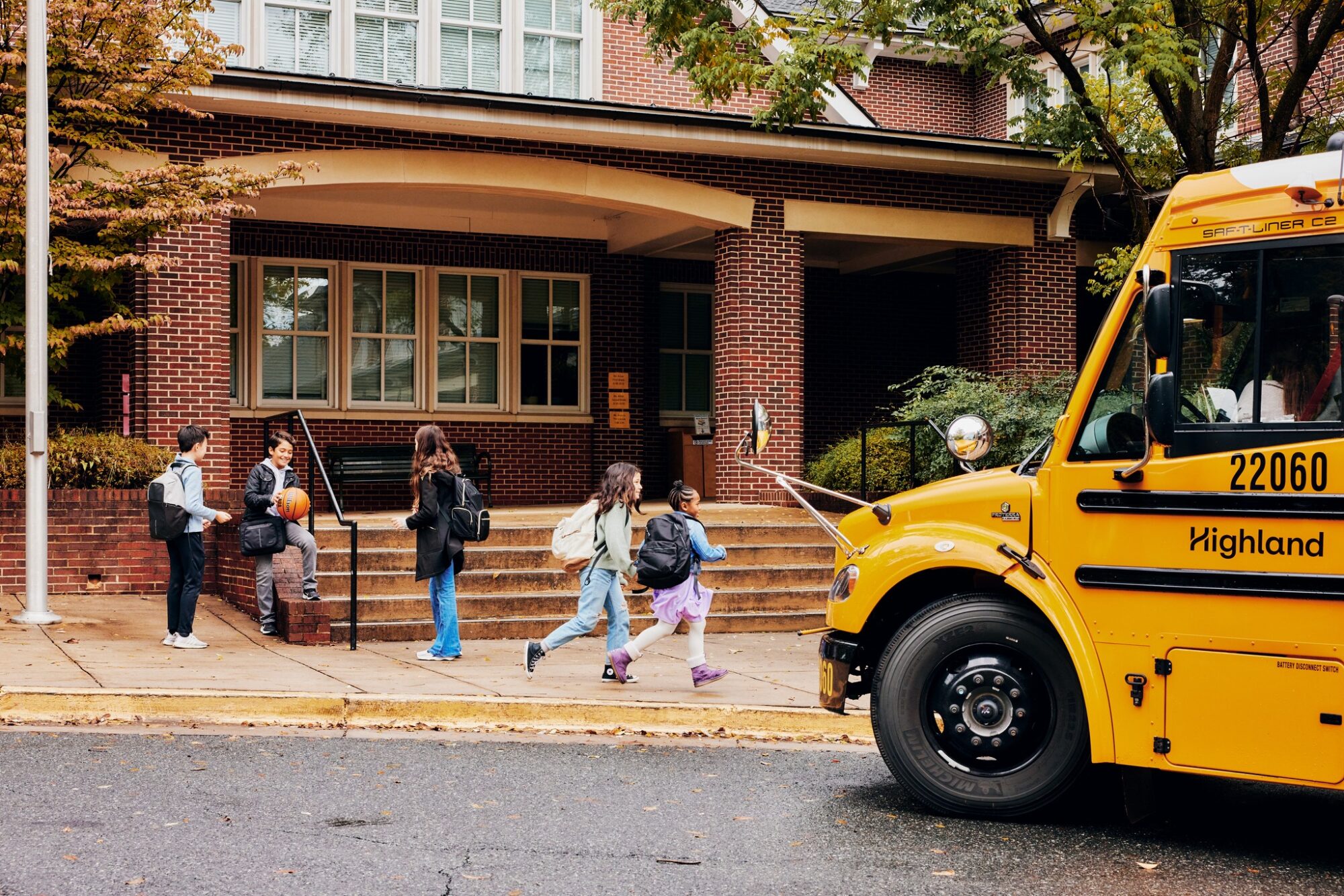 Kids running to get on the bus.
