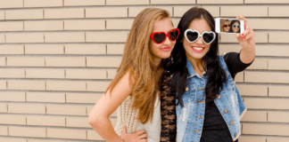 It’s a Girl’s World Trendy teen girls taking a selfie.