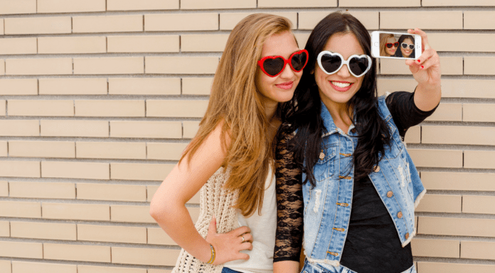 It’s a Girl’s World Trendy teen girls taking a selfie.