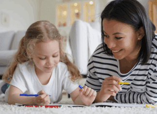 An au pair teaching a little girl.