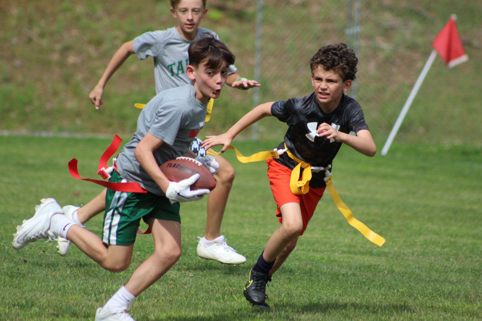 Boys playing flag football.