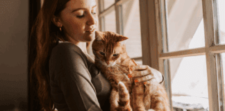 A woman holding a cat.