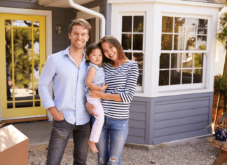 To Move or Not to Move? A family standing outside of their new home.