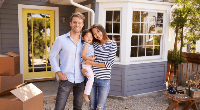 A family standing outside of their new home.