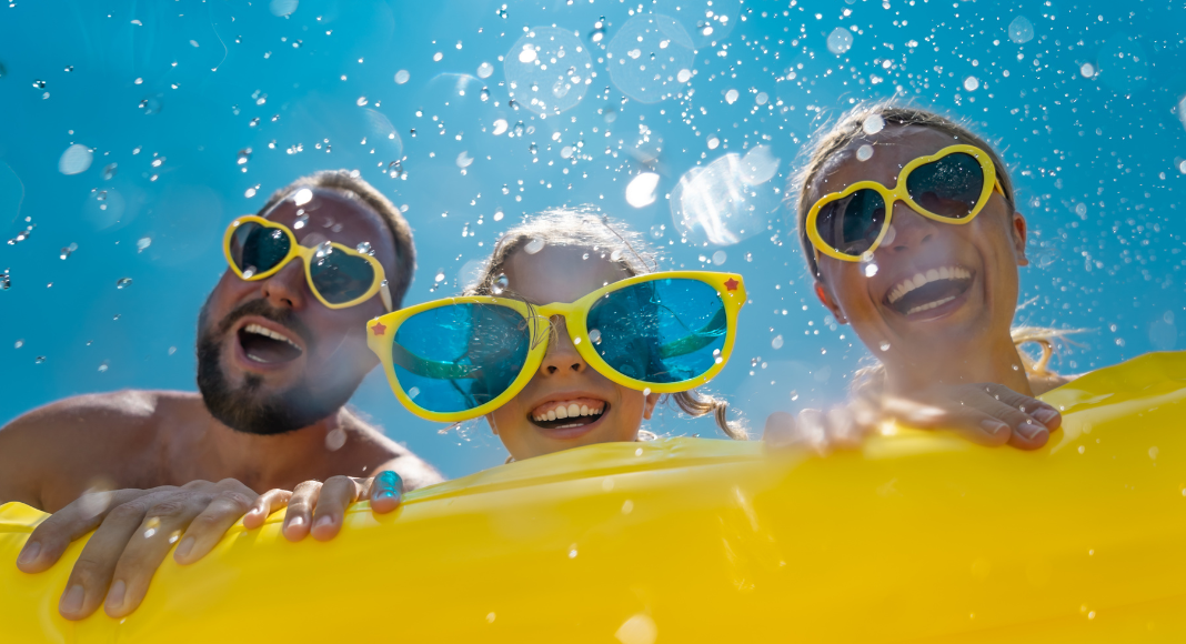 A family having fun int he water with a float.