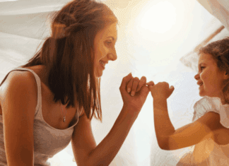 The Quiet Grief of Motherhood: Mourning Milestones A mom making a pinky promise with her daughter.