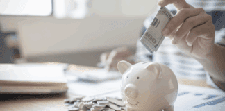 Putting money in a piggy bank.