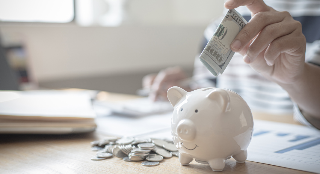 Putting money in a piggy bank.