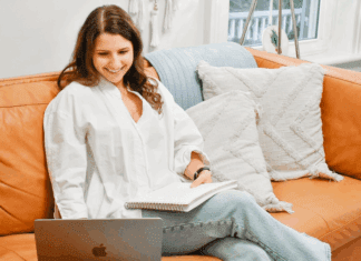 Diapers, Daycare, and a Financial Epiphany: Meet Brooke Brooke sitting on her couch on the computer.