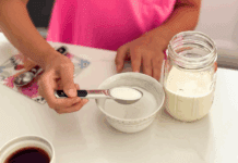 Adding sugar to a mason jar to make your own ice cream.