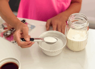 Adding sugar to a mason jar to make your own ice cream.