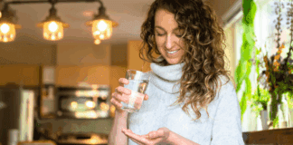 A woman taking a magnesium pill.