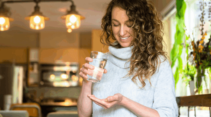 A woman taking a magnesium pill.