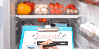 Looking into the fridge for writing a meal prep list.