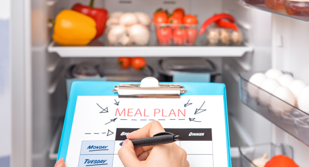 Looking into the fridge for writing a meal prep list.