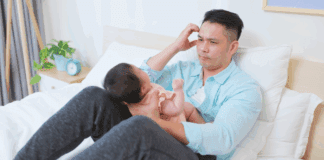 Is Dad All Right? A father struggling holding a baby.