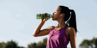 A woman drinking water after a workout.