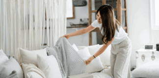 The 2:30 Rule: A Simple Productivity Hack for Moms A woman tidying up the couch.