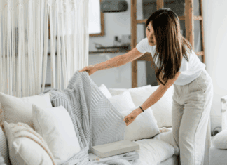 The 2:30 Rule: A Simple Productivity Hack for Moms A woman tidying up the couch.