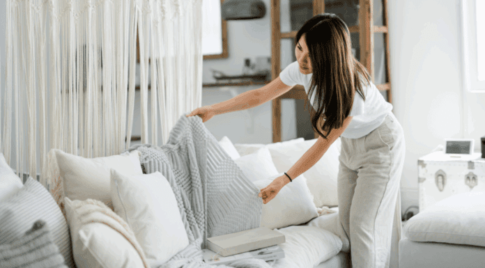 The 2:30 Rule: A Simple Productivity Hack for Moms A woman tidying up the couch.