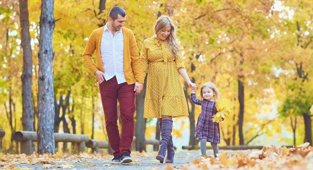 A family walking together on a fall day in one of the Westchester river towns